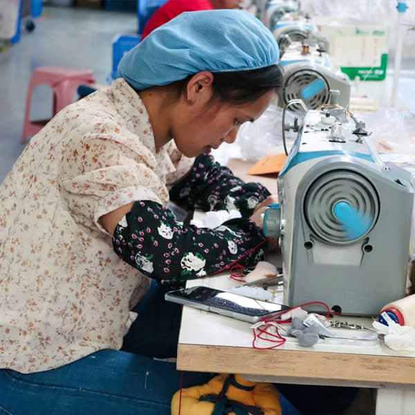 Hand-sewing a custom plush in our workshop